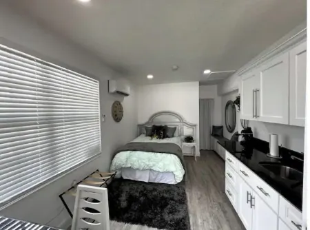 Modern studio apartment with covered outside seating area