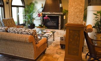 a cozy living room with a fireplace and a large flat - screen tv mounted on the wall at Inn on the Lakes