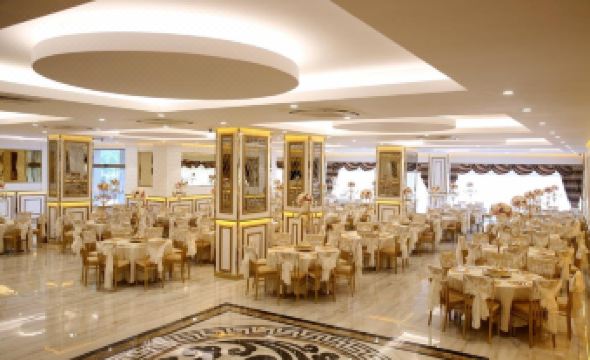 a large banquet hall with numerous dining tables and chairs , creating a formal and elegant atmosphere at Emirtimes Hotel&Spa - Tuzla