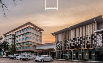 a modern building with a black and white checkered facade is next to a parking lot at Gallery Design