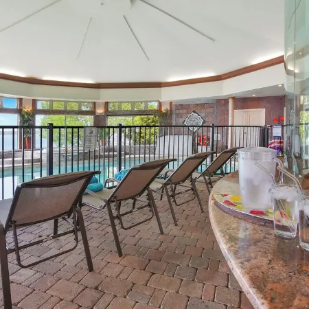 Stunning waterfront villa with indoor pool and kids swing set and play area.
