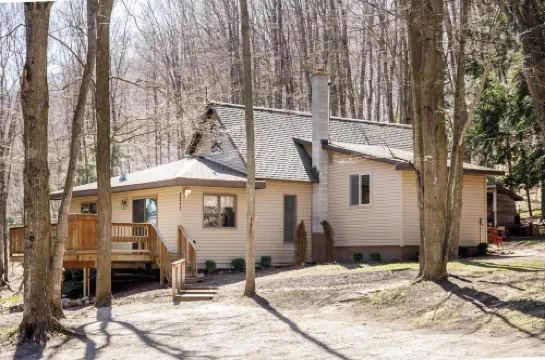 Centrally located cozy cottage tucked into the woods, a perfect family retreat