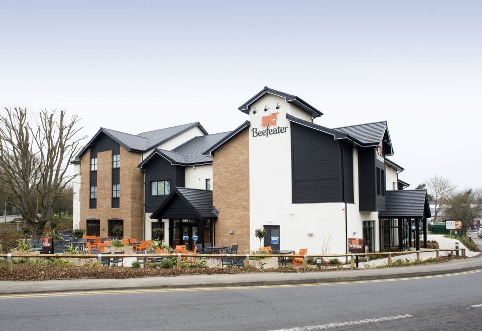 a large hotel building with a black and white color scheme , located on a city street at Premier Inn Ware