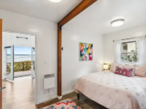 Darling pink beach house with epic views in a cozy community.