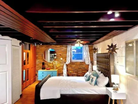 Live in this iconic East Side lower level apartment