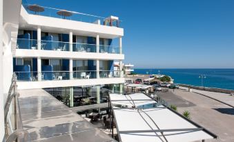 a large white building with multiple balconies overlooking the ocean , creating a picturesque view at Hotel Belvedere