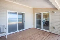 Dramatic oceanfront views. Open high ceilings. Huge deck & walls of windows!