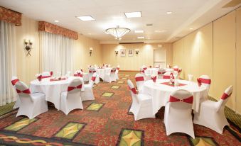 a conference room with tables and chairs set up for a meeting or event , surrounded by curtains at Hilton Garden Inn Casper