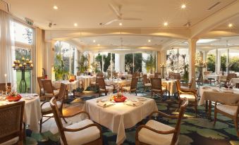 a large , elegant dining room with multiple tables and chairs arranged for a formal event at Suitenhotel Parco Paradiso
