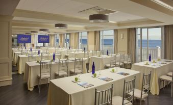 a large conference room with multiple tables and chairs , all set up for a meeting at Nantasket Beach Resort