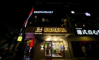 "a storefront of an establishment called eureka , lit up at night , with the name "" eureka "" visible" at Eureka Hotel Penang