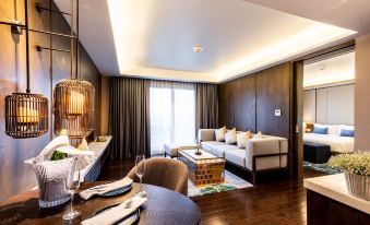 a modern living room with a couch , chair , and dining table is shown in the image at Divalux Resort and Spa Bangkok, Suvarnabhumi Airport-Free Shuttle