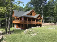 Luxury Log home steps from private beach in Meredith on Lake Winnipesaukee.