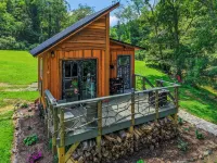 Tiny cabin sits by a bubbling, stocked creek. Pet friendly for a fee, hot tub
