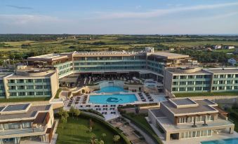aerial view of a large hotel with a swimming pool surrounded by green grass and trees at Kempinski Hotel Adriatic Istria Croatia
