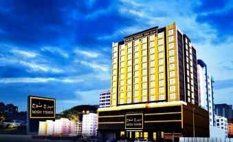 "a tall hotel building with many windows and a sign that says "" casa del cortador "" in the background" at Nooh Tower