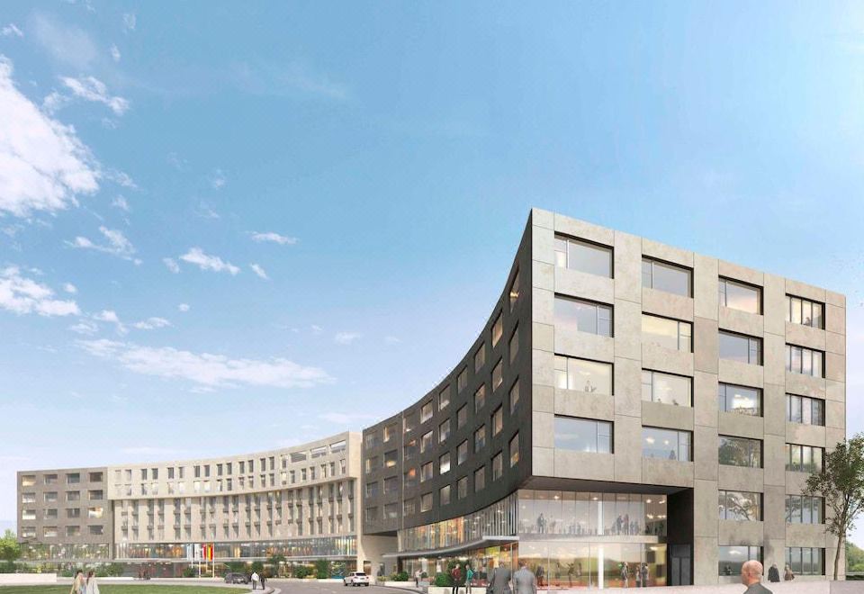 a modern building with a curved facade is surrounded by people and cars on a city street at Mercure Geneva Airport