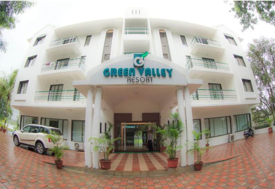 "a large building with the sign "" green valley resort "" prominently displayed on the front of the building" at Green Valley Resort