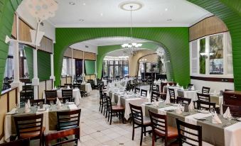 A dining room is set up for business lunches, with tables and chairs arranged in the center at Anew Hotel Parktonian Johannesburg