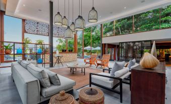 a spacious living room with multiple couches and chairs , creating a cozy and inviting atmosphere at Wyndham Ilhabela Casa di Sirena