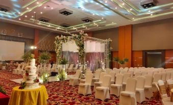a large banquet hall decorated for a wedding reception , with tables , chairs , and flowers in the center at Aquarius Boutique Hotel Sampit