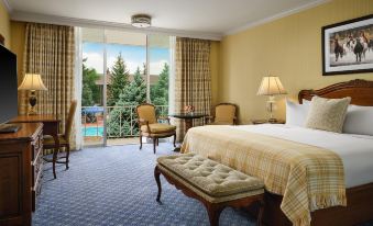 a spacious bedroom with a large bed , a chair , and a window overlooking a pool at Little America Hotel & Resort Cheyenne