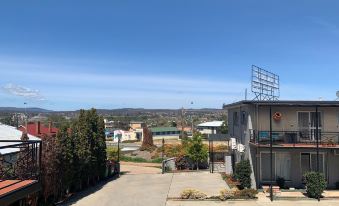 a view of a residential area with houses and trees , taken from the perspective of a balcony at Crest Motor Inn