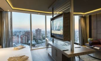a modern hotel room with a large window offering a city view , a comfortable bed , and a flat - screen tv on the wall at Icon Hotel