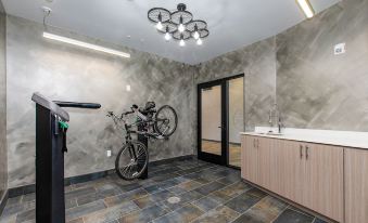 a bicycle is leaning against a wall in a room with a sink and cabinets at The Independence Hotel