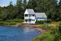 Sea-Breeze Cottage perched on the edge of the bay.