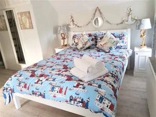 Charming  Listed Thatched Cottage with parking and short walk to sandy beach .