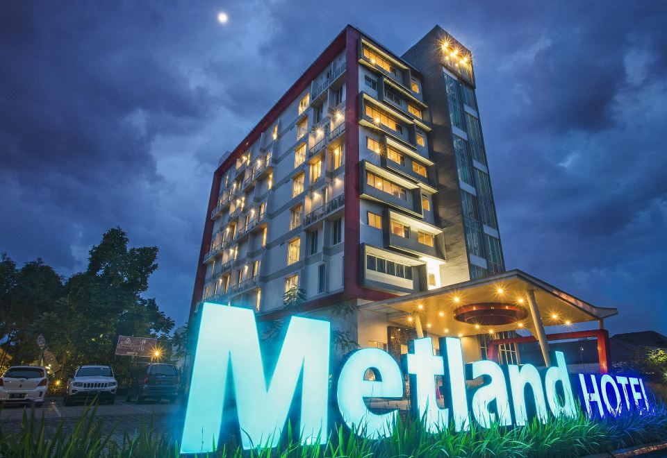 "a large hotel building with a sign that reads "" metland "" prominently displayed on the front" at Metland Hotel Cirebon by Horison