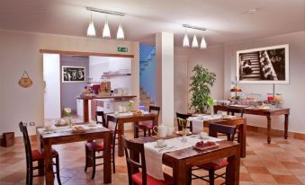 a large dining room with multiple tables and chairs arranged for a group of people to enjoy a meal together at Marin Hotel