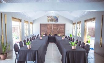 a large conference room with multiple tables and chairs arranged for a meeting or event at Le Life Resort