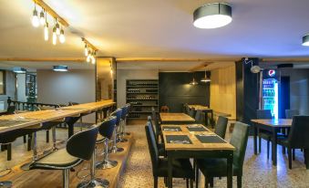 a dining room with wooden tables and chairs , as well as a kitchen area with a sink at Hotel Austria