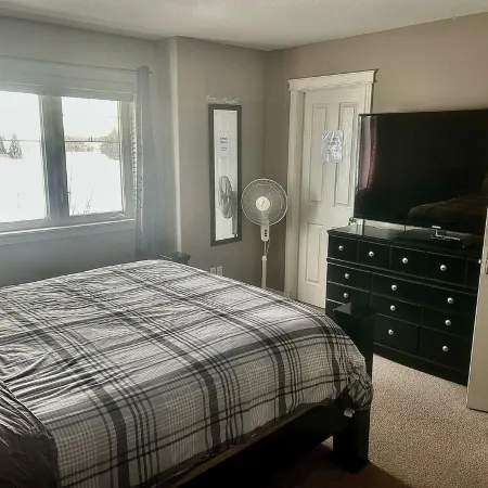 Spacious 4-bedroom townhome in charming Red Deer with WiFi, AC