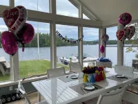 Stunning lakefront home with a boathouse, private dock, firepit and lake views