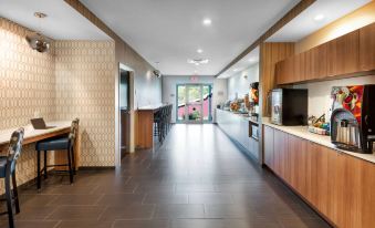 a long , well - lit hallway with wooden cabinets and a sliding glass door leading to an outdoor area at Microtel Inn & Suites by Wyndham Warsaw