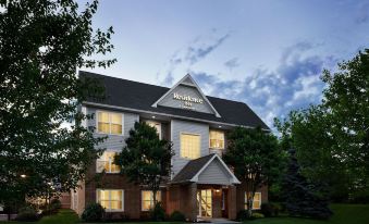 "a large , two - story building with a sign that reads "" reserve hotel "" is surrounded by trees and grass" at Residence Inn Harrisburg Carlisle