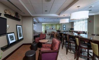 a hotel lobby with several chairs and couches , creating a comfortable and inviting atmosphere for guests at Hampton Inn Bath (Brunswick Area)