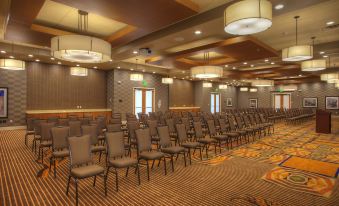 a large conference room with rows of chairs arranged in a semicircle , ready for an event at SpringHill Suites Deadwood