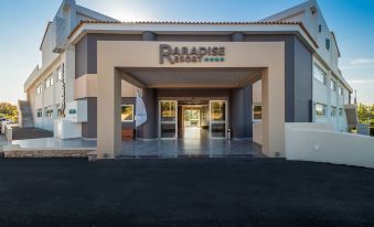 "the exterior of a building with the name "" paradise place "" displayed above the entrance" at Paradise Resort