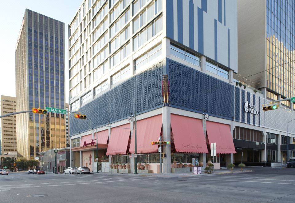 a city street with a tall building and several other buildings , including an office building at Hotel Indigo El Paso Downtown