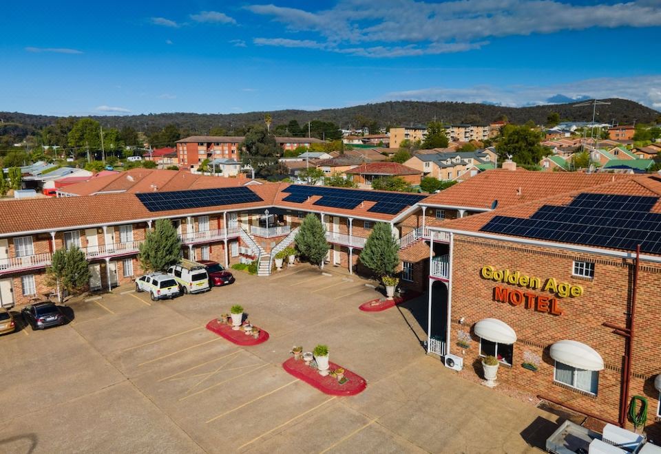 "a large building with a red roof and the words "" cornhill hotel "" on it" at Golden Age Motor Inn