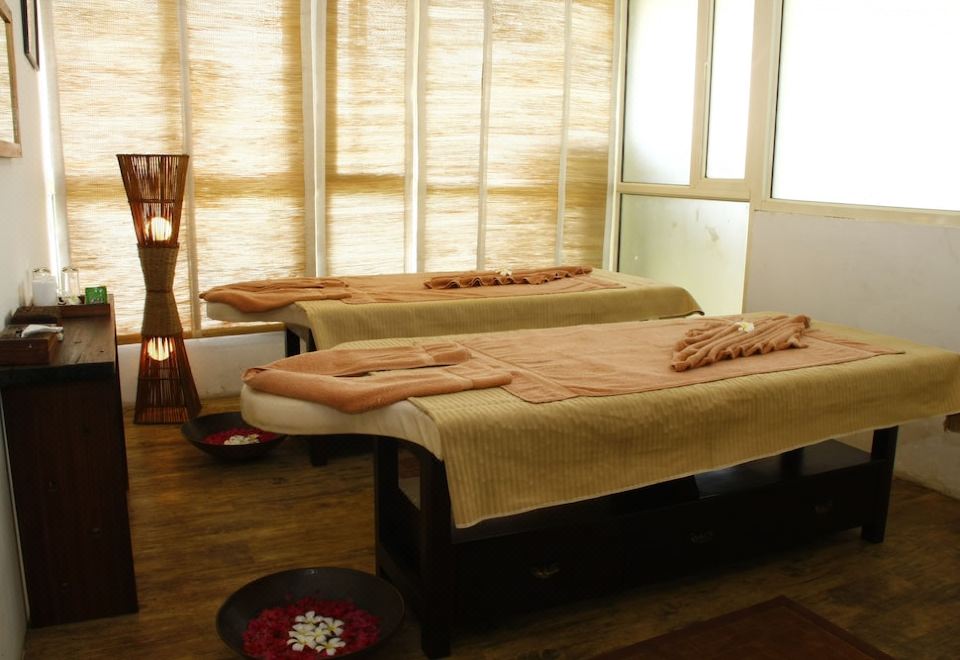 a room with two massage tables , one on the left and one on the right , covered with towels at Beleza by the Beach