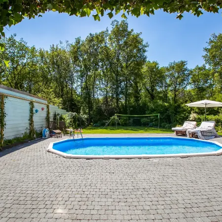 A Detached Bungalow with Outdoor Fireplace Covered Terrace and Pond in a Forest Plot
