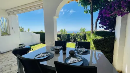 Modern garden apartment with a fantastic view of the sea and a private garden