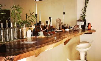 a wooden bar counter with various bottles and cups on it , creating a cozy atmosphere at Casa del Mar