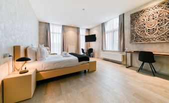 a large bed with a wooden headboard is in the middle of a room with wooden floors at Hotel Acropolis