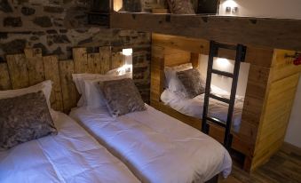 a room with two twin beds , one on top of the other , and a wooden headboard at Trail Lodge